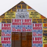 Photo of a house with I buy houses signs